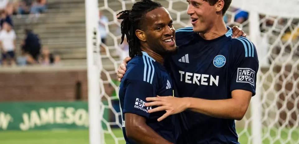 Players celebrating after a goal during match