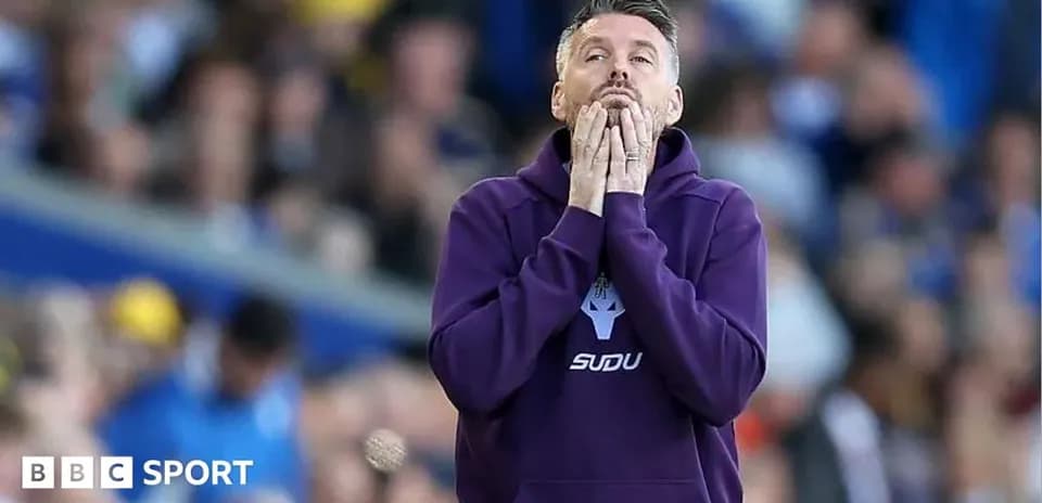 Coach with hands on face during tense moment