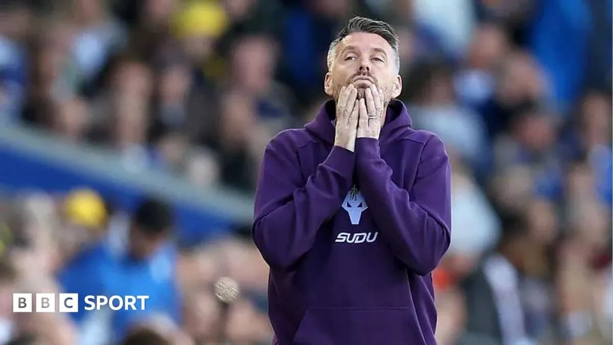 Coach with hands on face during tense moment