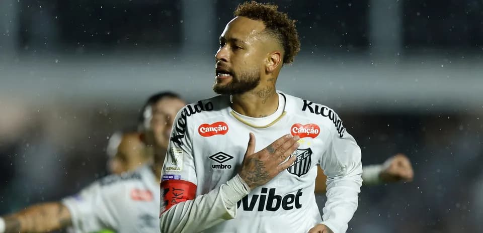 Player celebrating after scoring a goal in rain