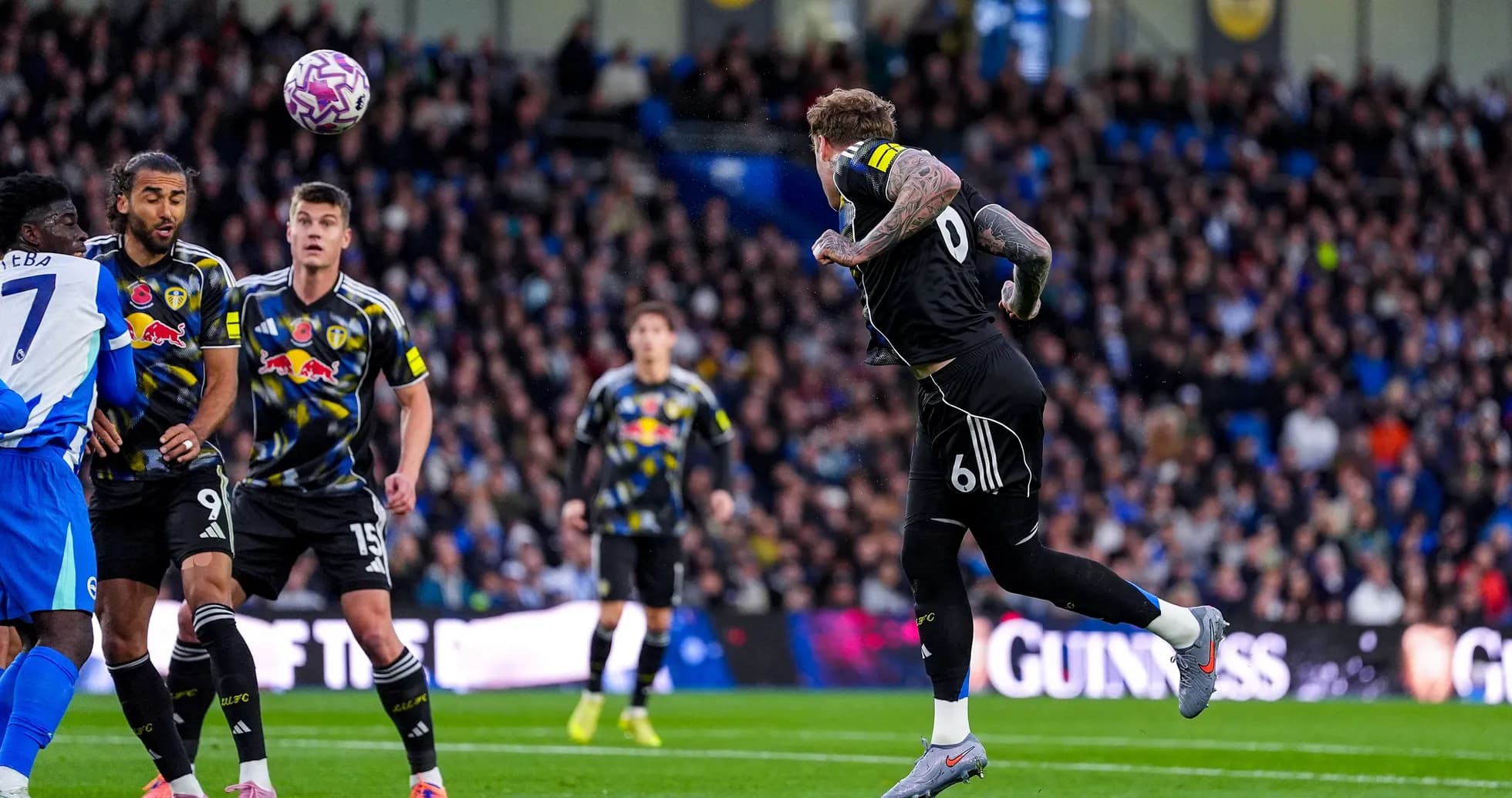 Leeds player heads ball during match against Brighton