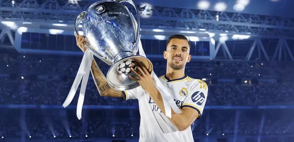 Player holding UEFA Champions League trophy at stadium