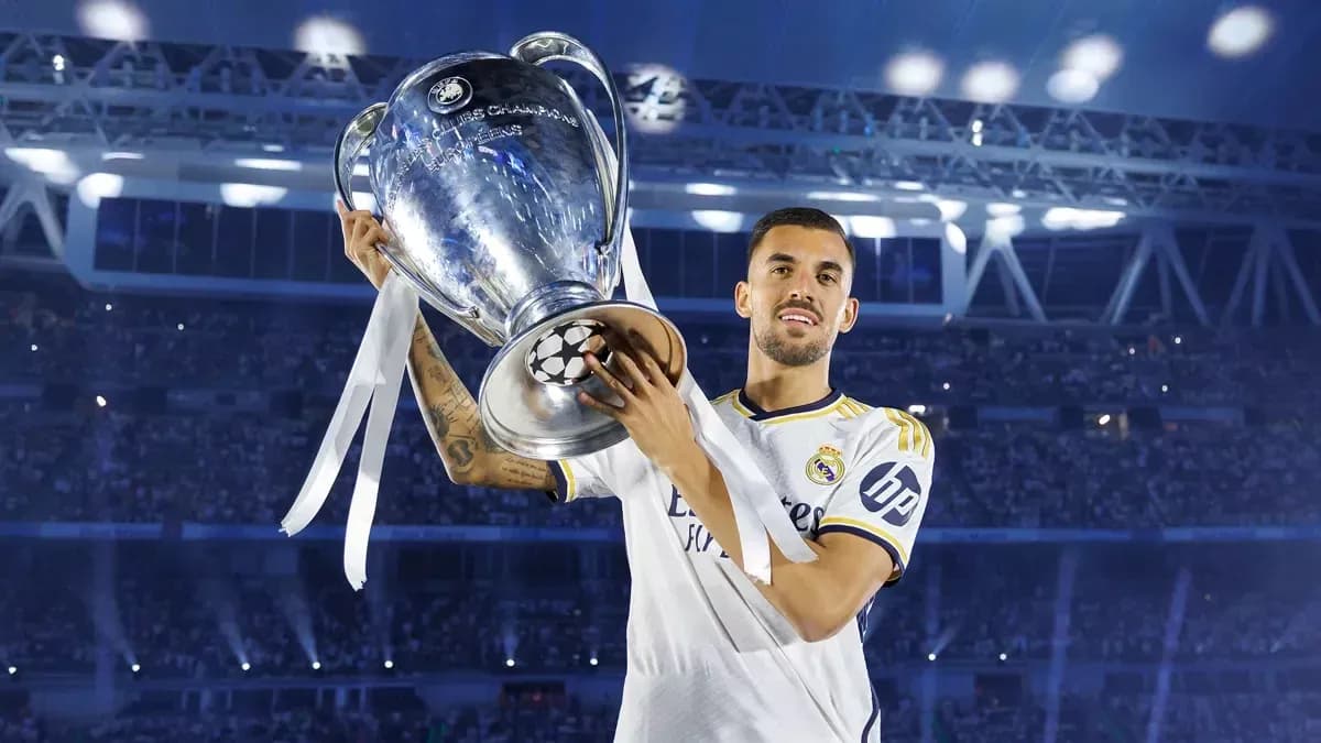 Player holding UEFA Champions League trophy at stadium