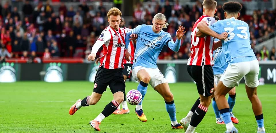 Players contesting the ball during Manchester City match