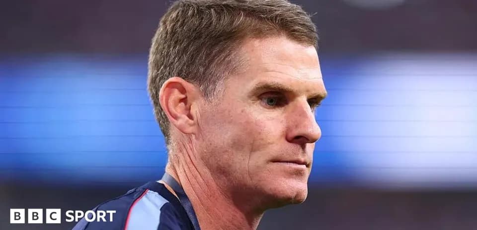 Coach focused during a match on the sidelines