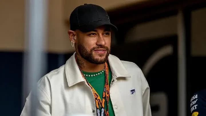Neymar wearing a white jacket and cap