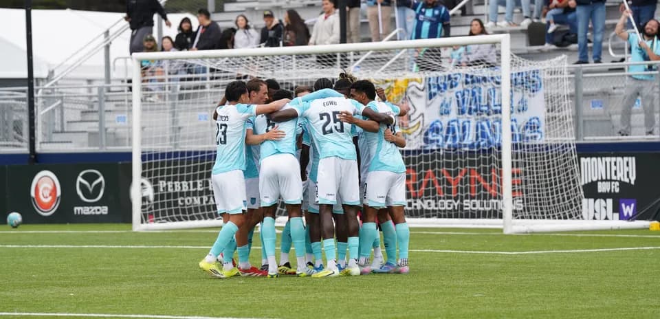 Players celebrating together during FC Tulsa match