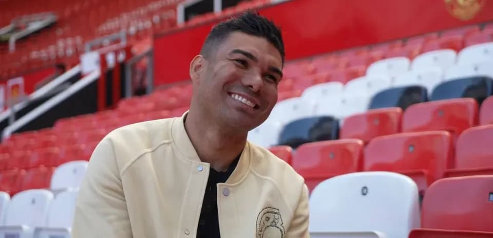 Player smiling while sitting in stadium seats