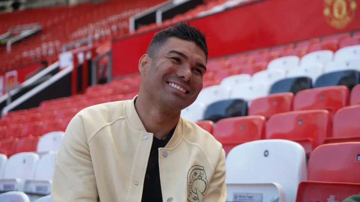 Player smiling while sitting in stadium seats