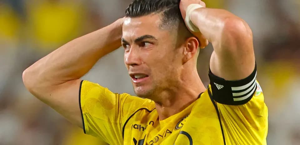 Player in yellow jersey reacting with frustration