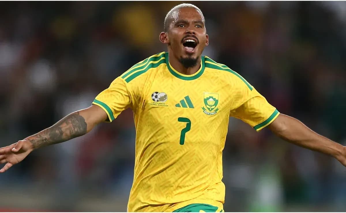 Player celebrating a goal in yellow South Africa kit