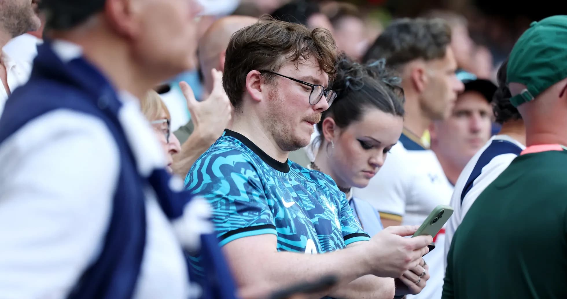 Fans looking at their phones during the event