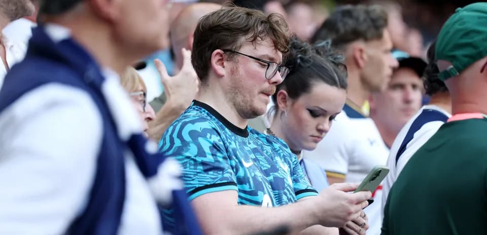 Fans looking at their phones during the event