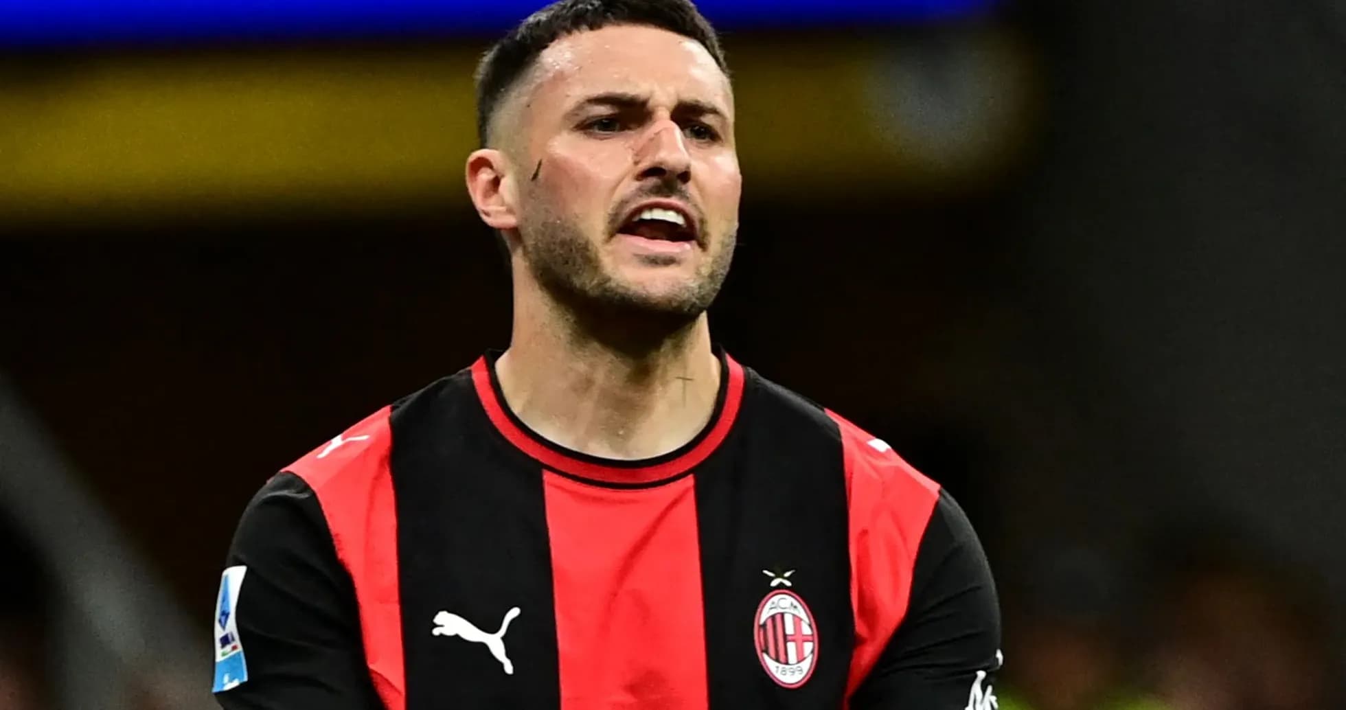 Player in AC Milan jersey reacting during match