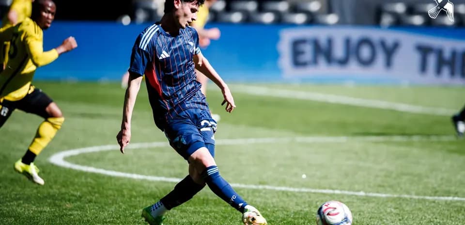Player kicking ball during New England II match