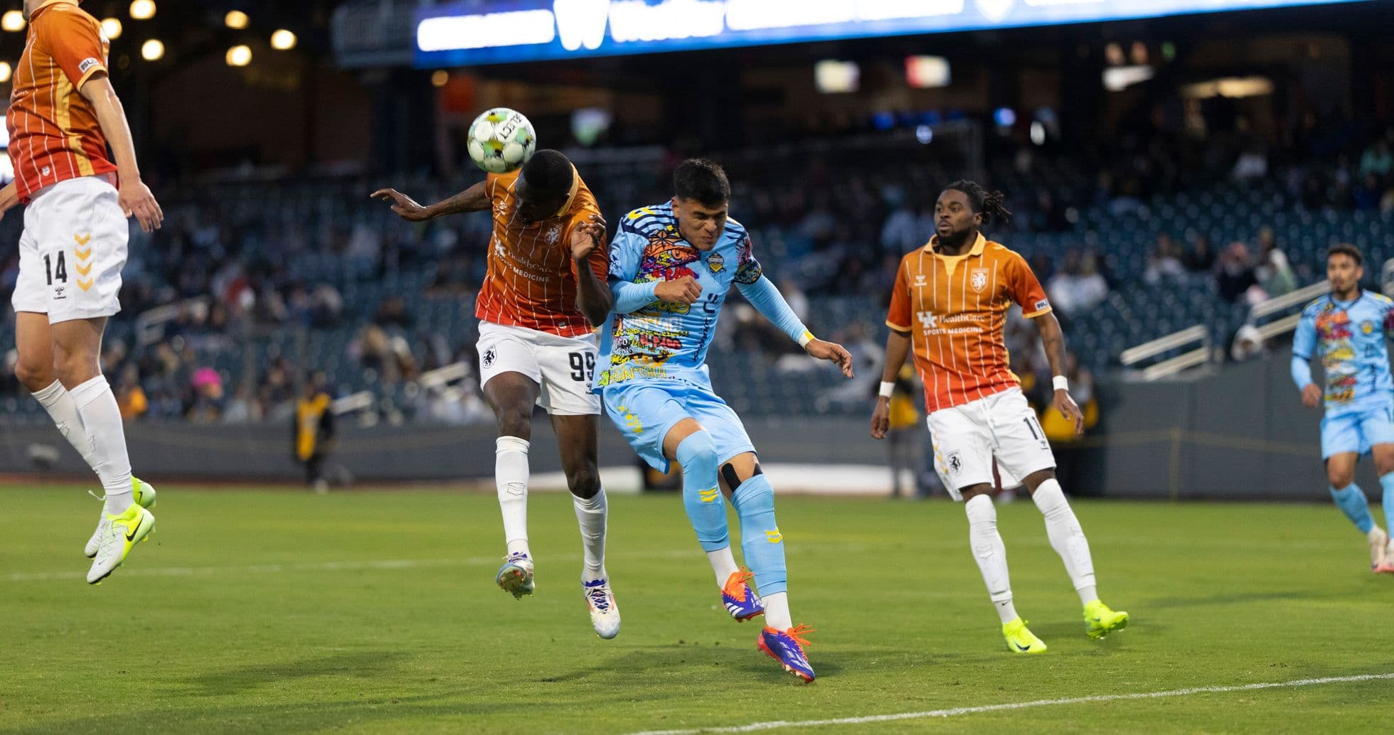 Players competing for the ball in USL match