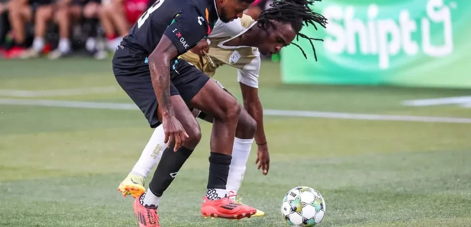 Players competing for the ball in USL match