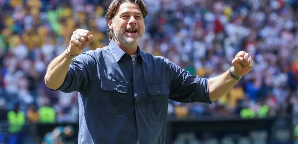 Coach celebrating enthusiastically during a match