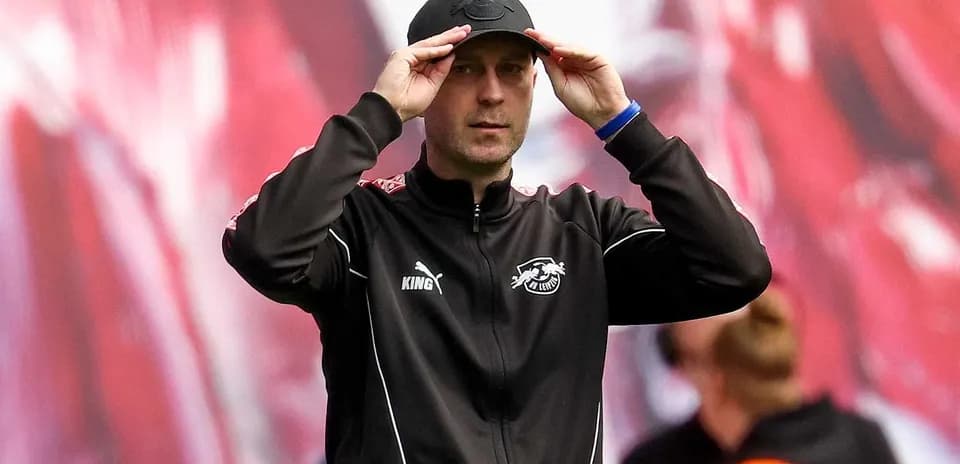 Coach adjusting cap during match on sidelines