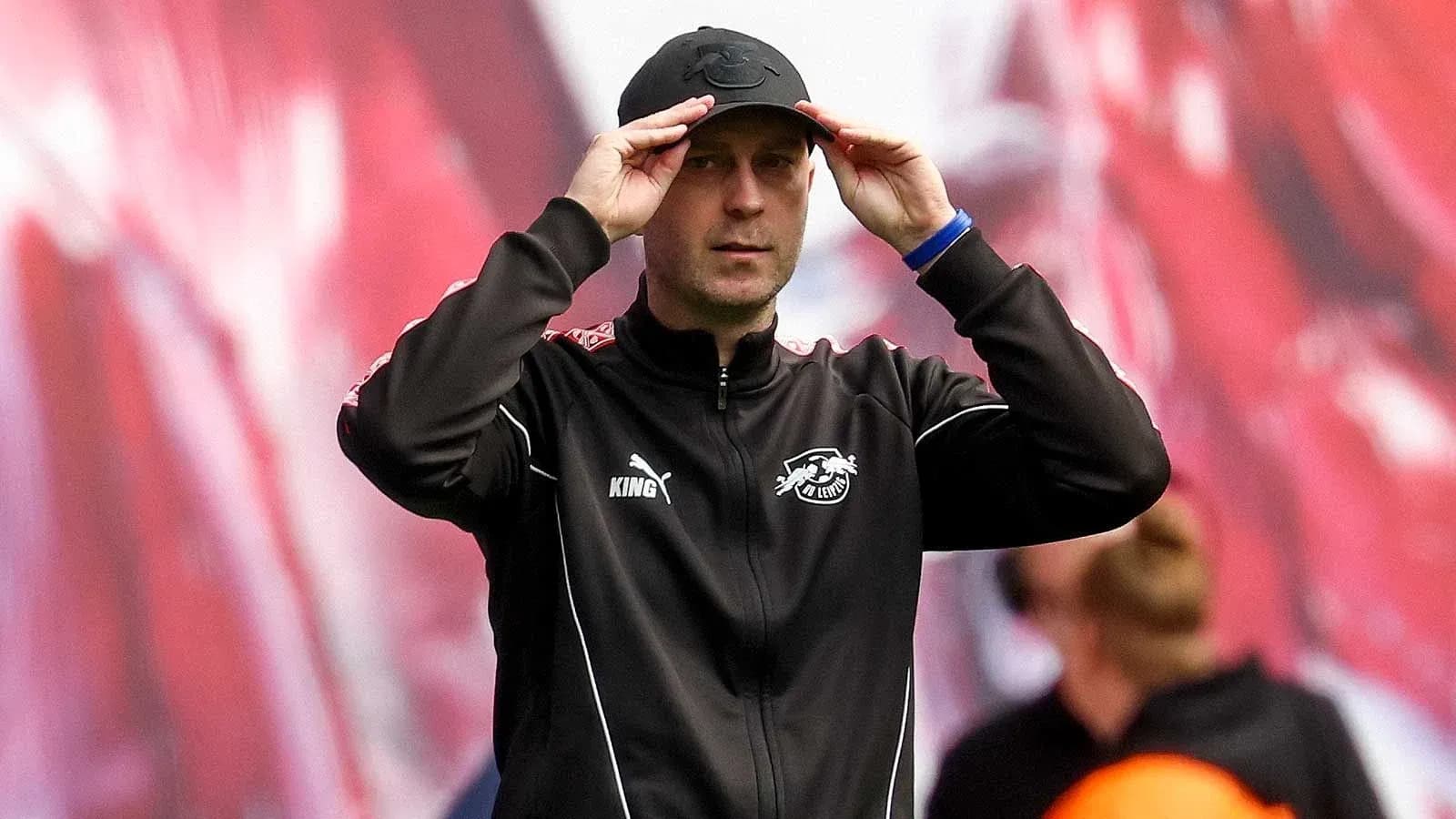 Coach adjusting cap during match on sidelines