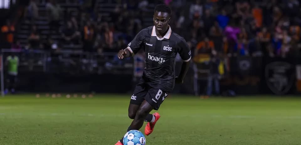 Player dribbling the ball during Miami FC match