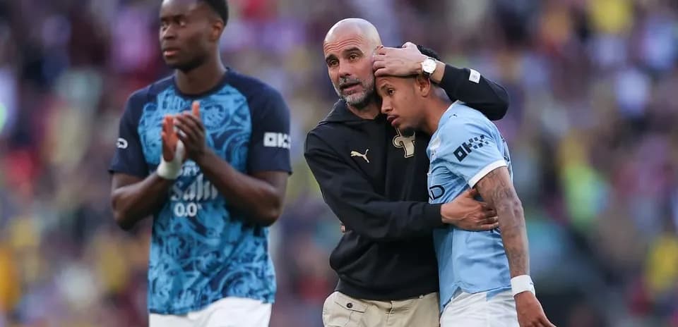 Coach comforting player after match on field