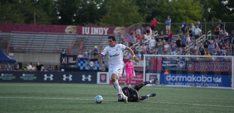 Player evading a tackle during Indy Eleven match