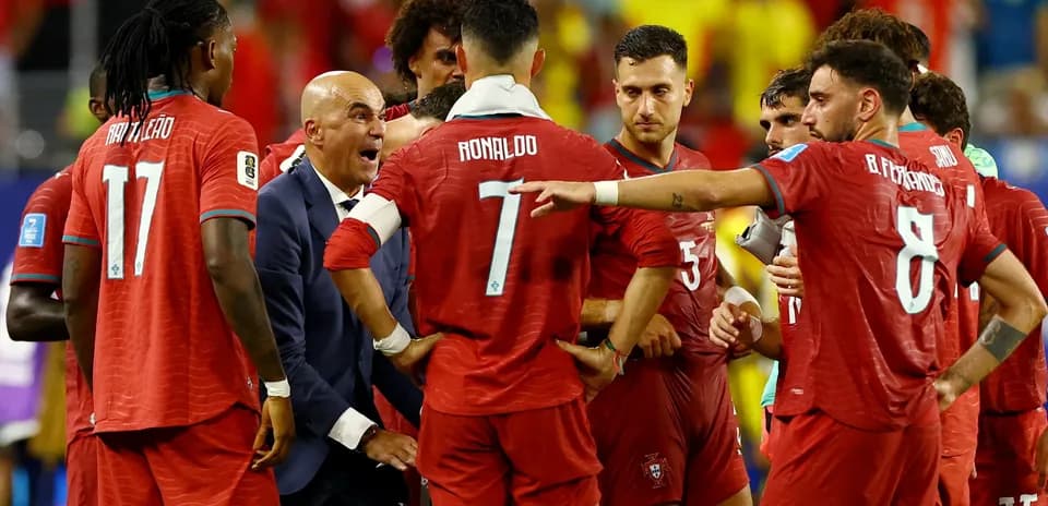 Portugal players discussing tactics during a match