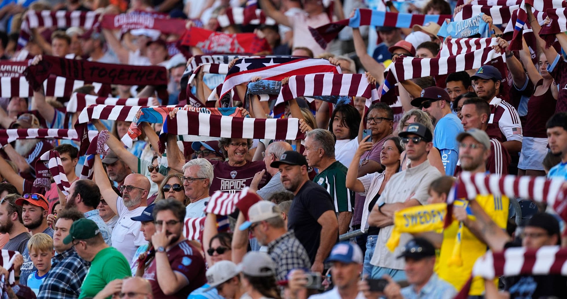 Fans cheering with scarves at Colorado match
