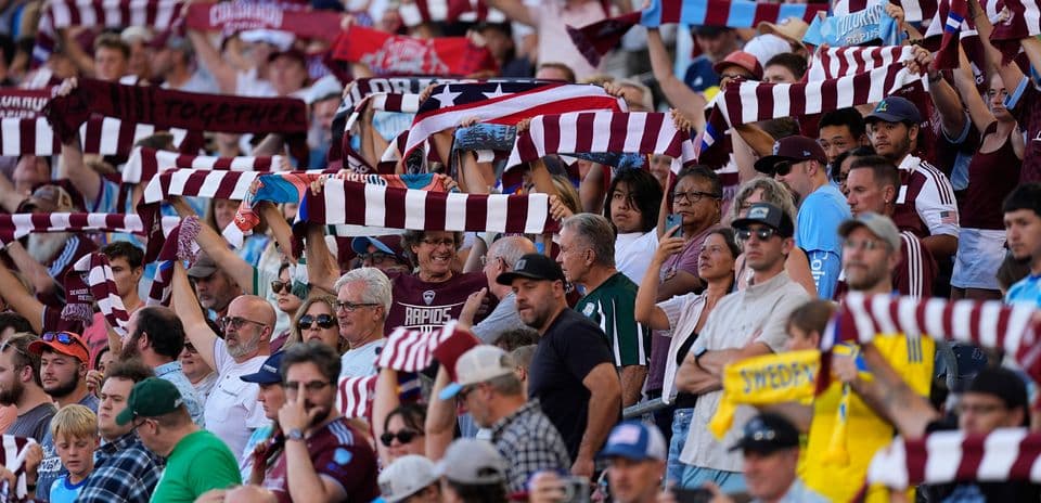 Fans cheering with scarves at Colorado match