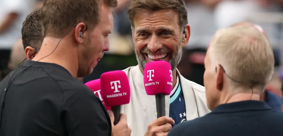 Four presenters holding microphones during a broadcast