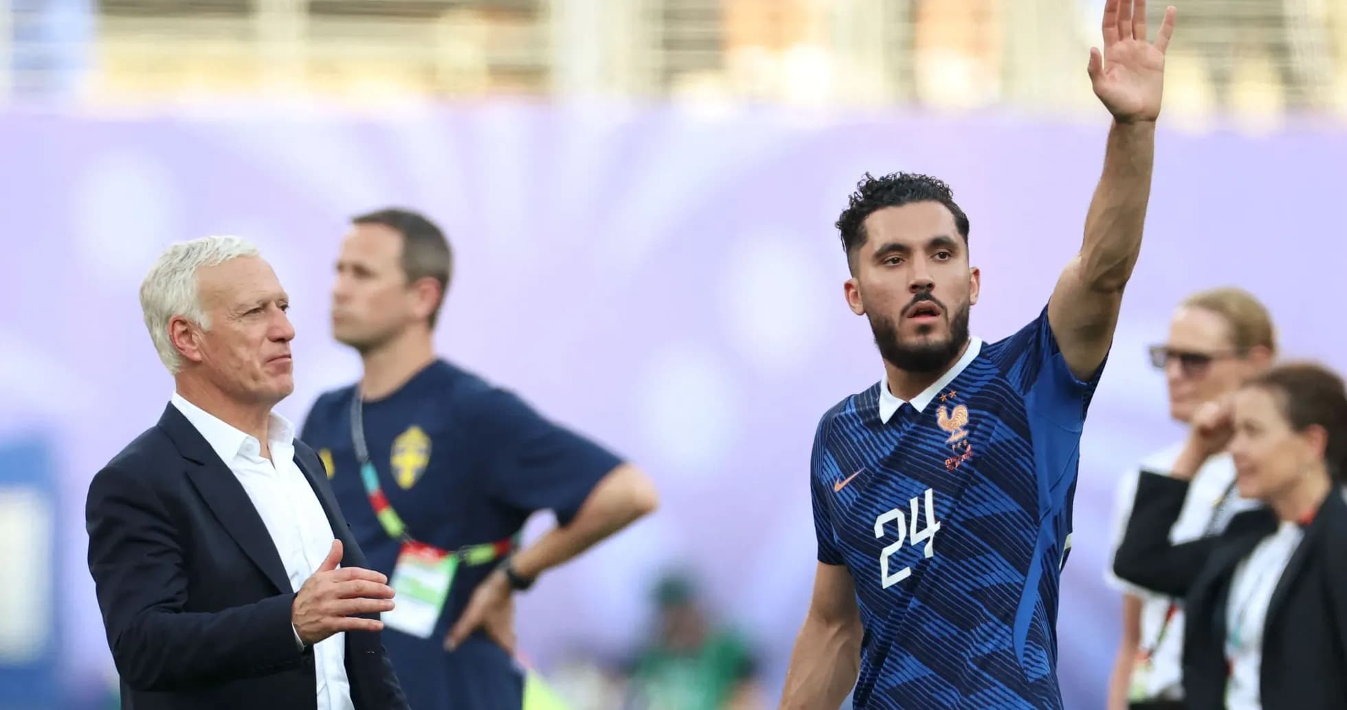 French player waving during match with coach nearby