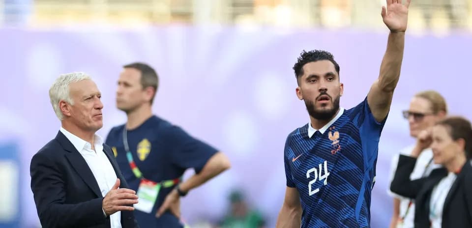 French player waving during match with coach nearby