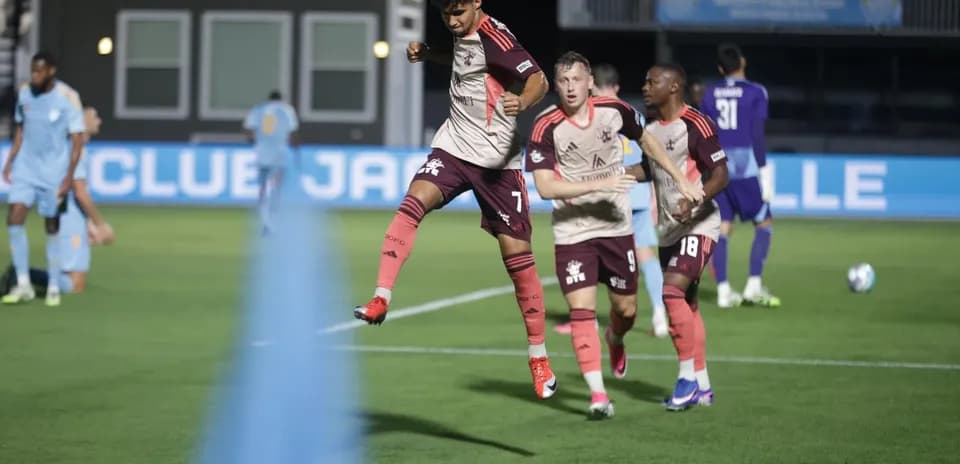 Player celebrating after scoring against Detroit City