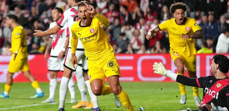 Player celebrating a goal against the goalkeeper