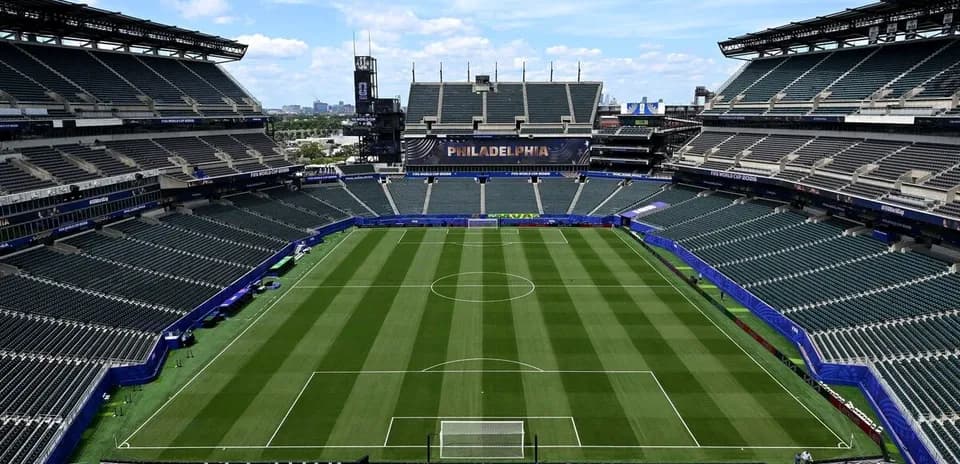 Empty soccer stadium with field and seating area