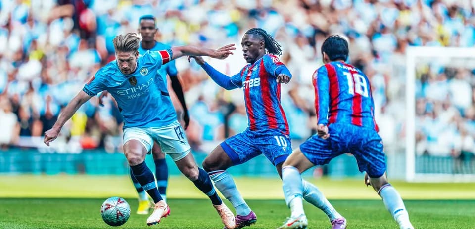 Manchester City player challenging Crystal Palace opponent
