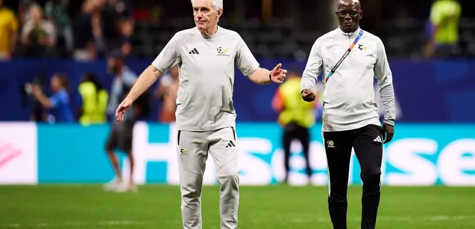 Coaches walking on the pitch before a match