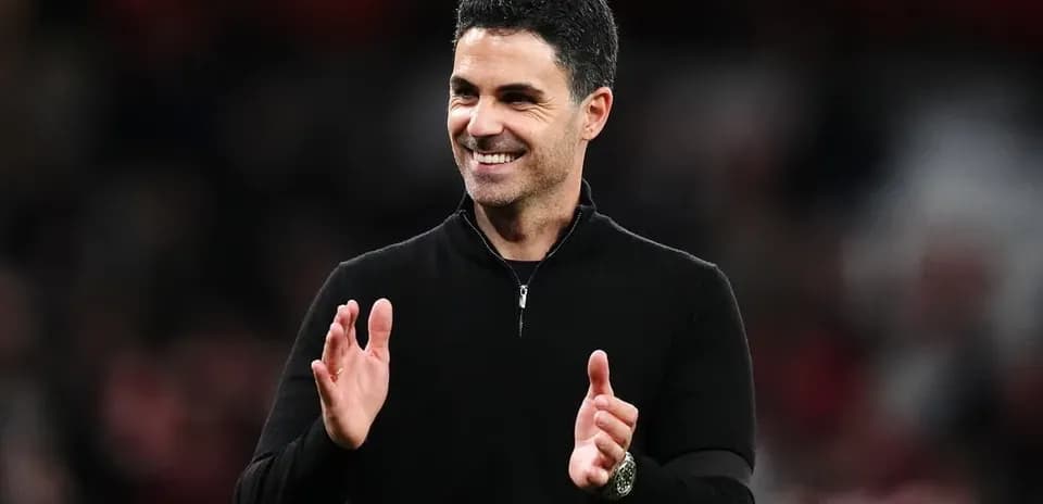 Manager clapping during a match at the stadium