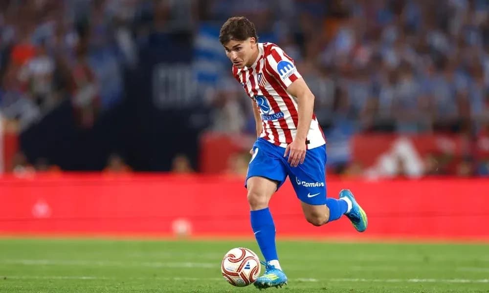 Player in Atlético Madrid kit dribbling the ball