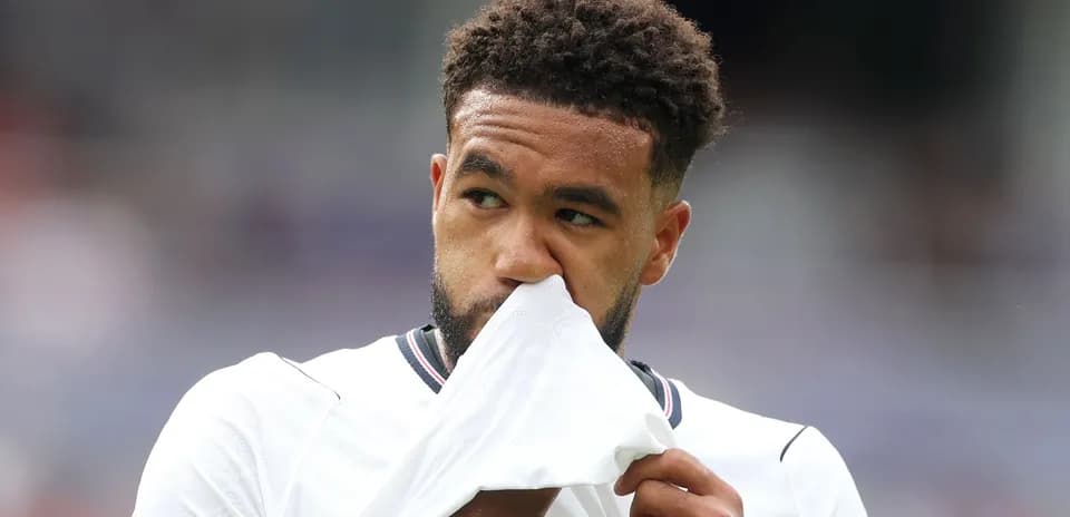 Player wiping his face with jersey during match