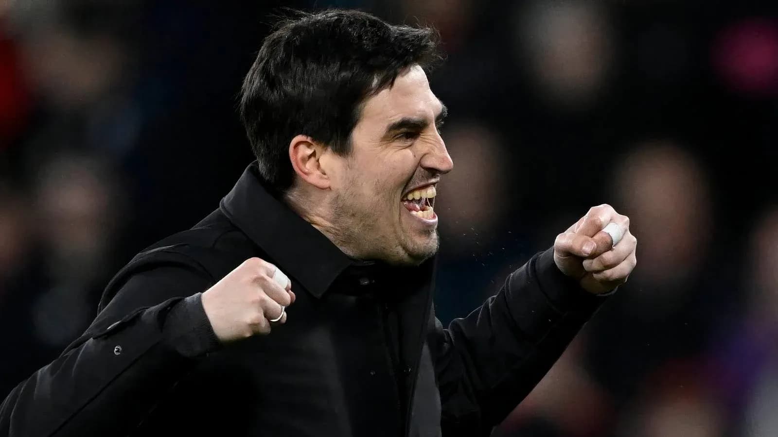Coach celebrating enthusiastically during a match