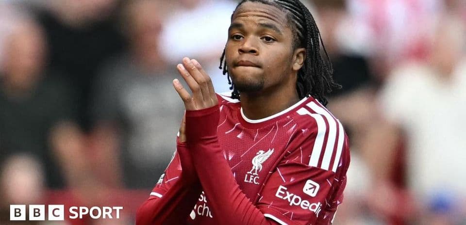 Player in Liverpool kit applauding fans in stadium