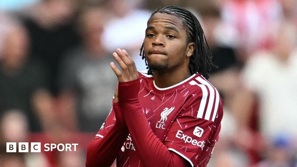 Player in Liverpool kit applauding fans in stadium
