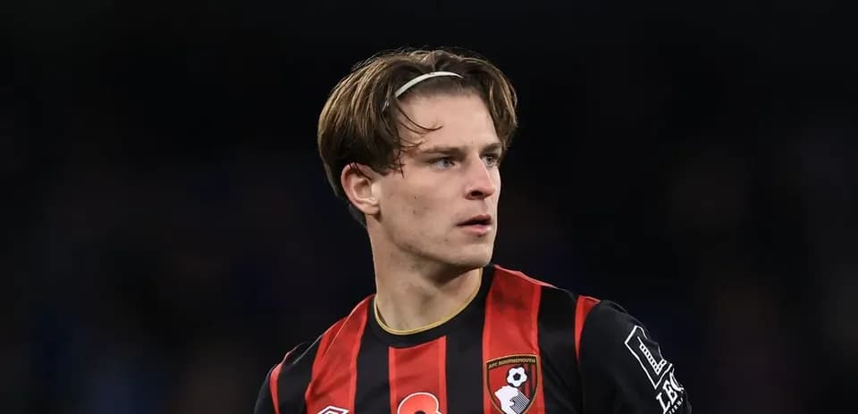 Bournemouth player in black and red kit on pitch