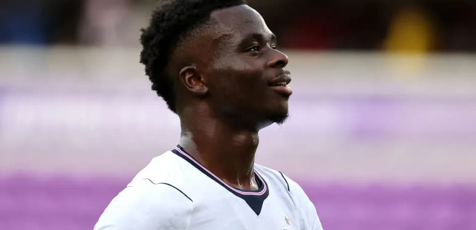 Player in England jersey smiling during match
