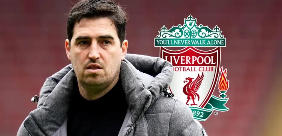 Man in coat near Liverpool FC logo background