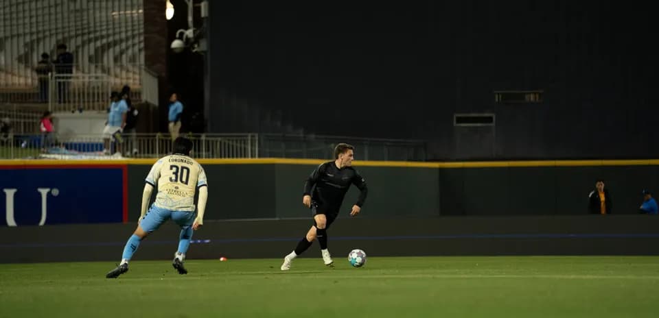 Player dribbling the ball during Colorado Springs match
