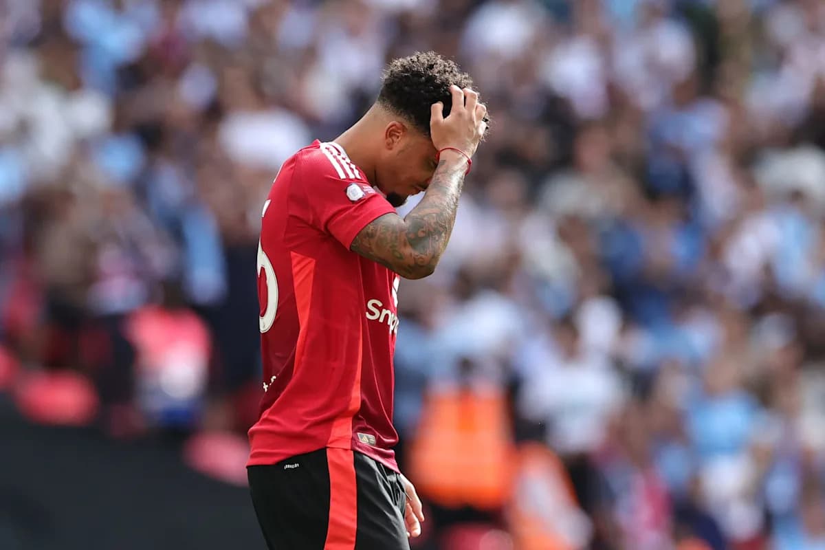 Player in red jersey looking dejected on field