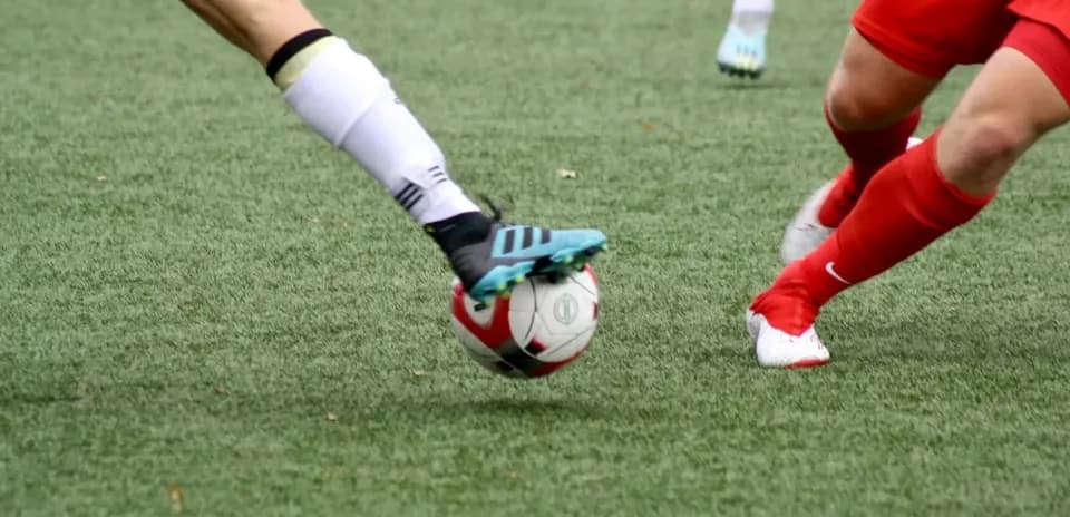 Players contesting for the ball during match